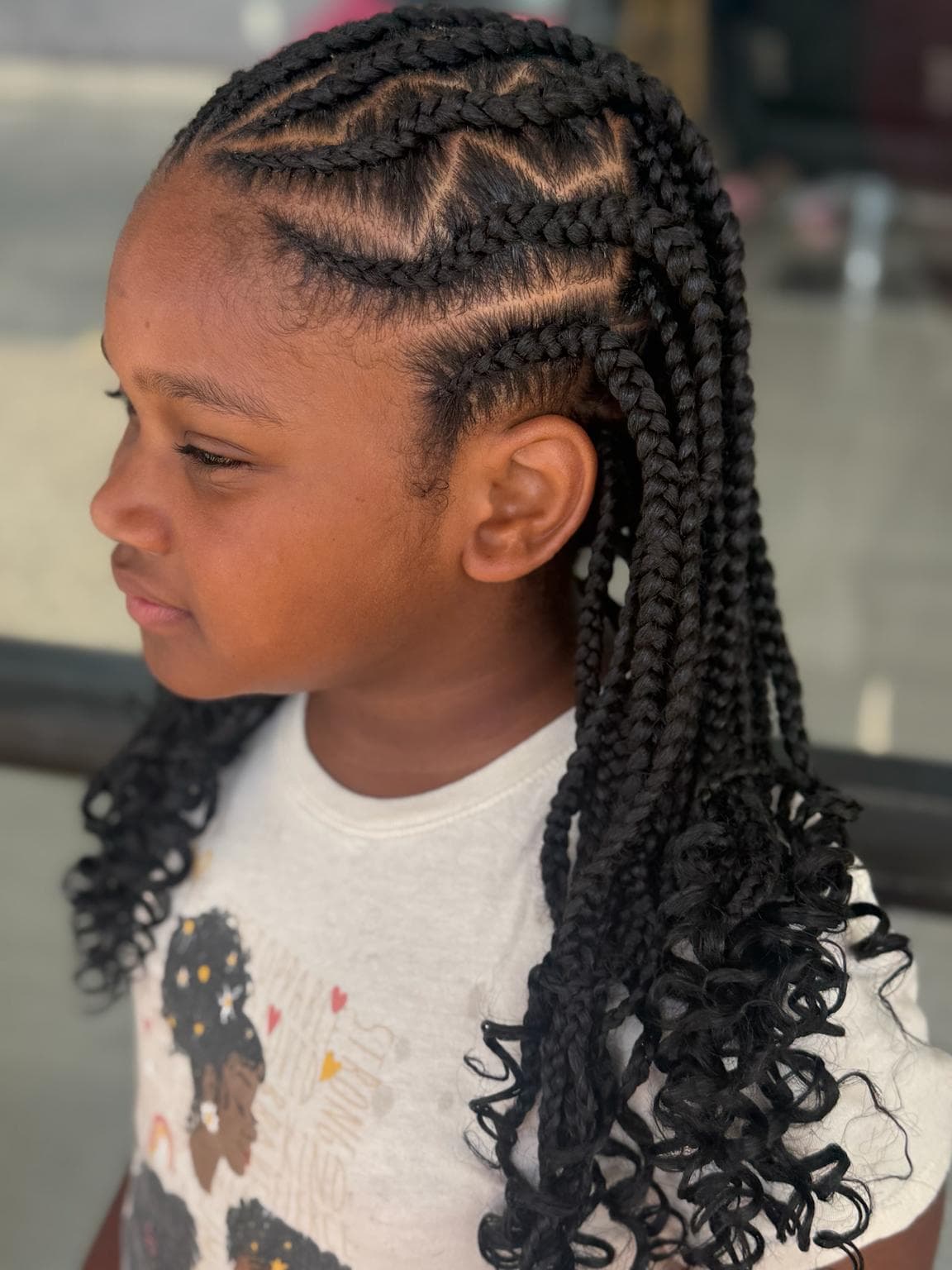 Black Medium Kids Stitch Braids with Curly Ends side View — Pejah Braiding client work