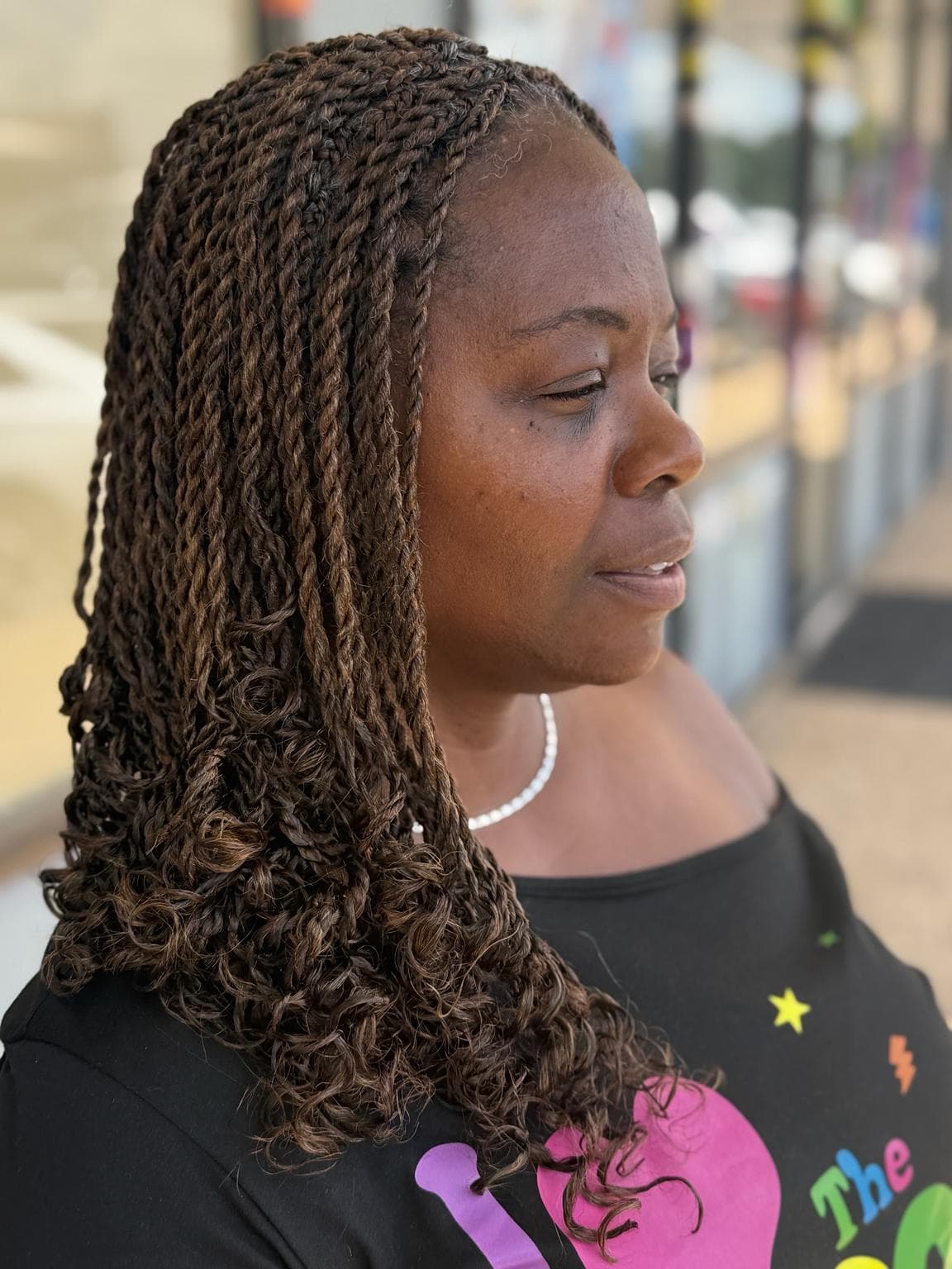 Medium Senegalese Twists with soft curly ends side view outdoor — Pejah Braiding client work